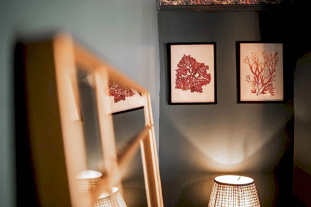 Discover a tasteful corner in this Anfield, Liverpool serviced accommodation where contemporary flair meets cosy ambience. Two framed coral prints in vibrant red hues are mounted on a deep...