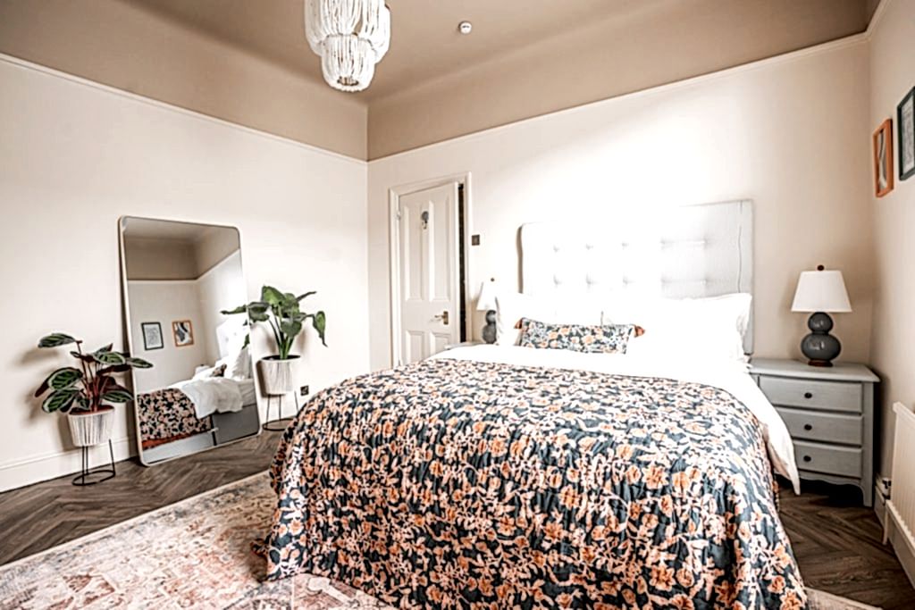 A beautifully staged bedroom in an Anfield, Liverpool serviced accommodation styled by WildKind Interiors. This room features a king-size bed dressed in crisp white linens...