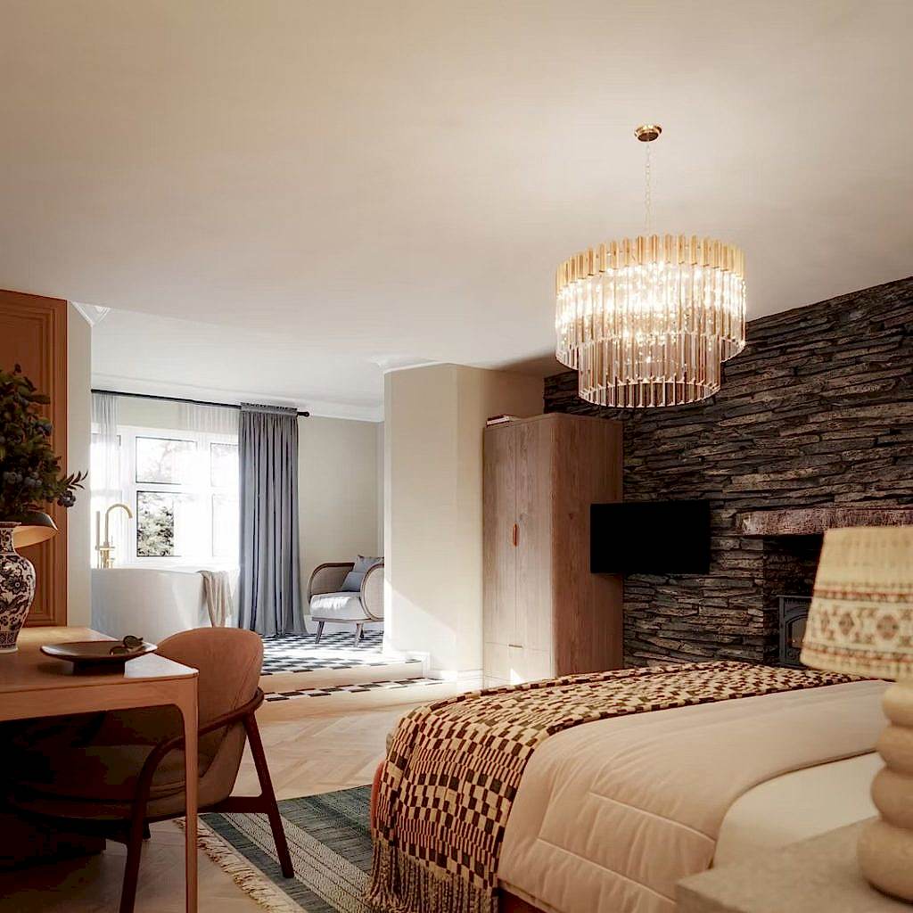 Studio suite with a slate stone feature wall, a tiered glass chandelier and a freestanding bath set within the bedroom.