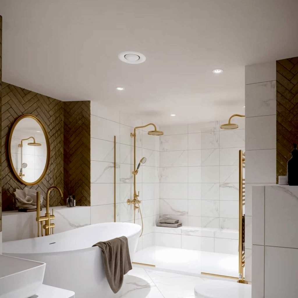 Spa-style bathroom with a freestanding tub, twin rainfall showers, marble tiling and brushed-gold fittings.