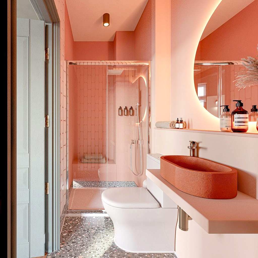 Spa-style ensuite in warm coral, with a terracotta basin, a round mirror and a walk-in shower over terrazzo flooring.