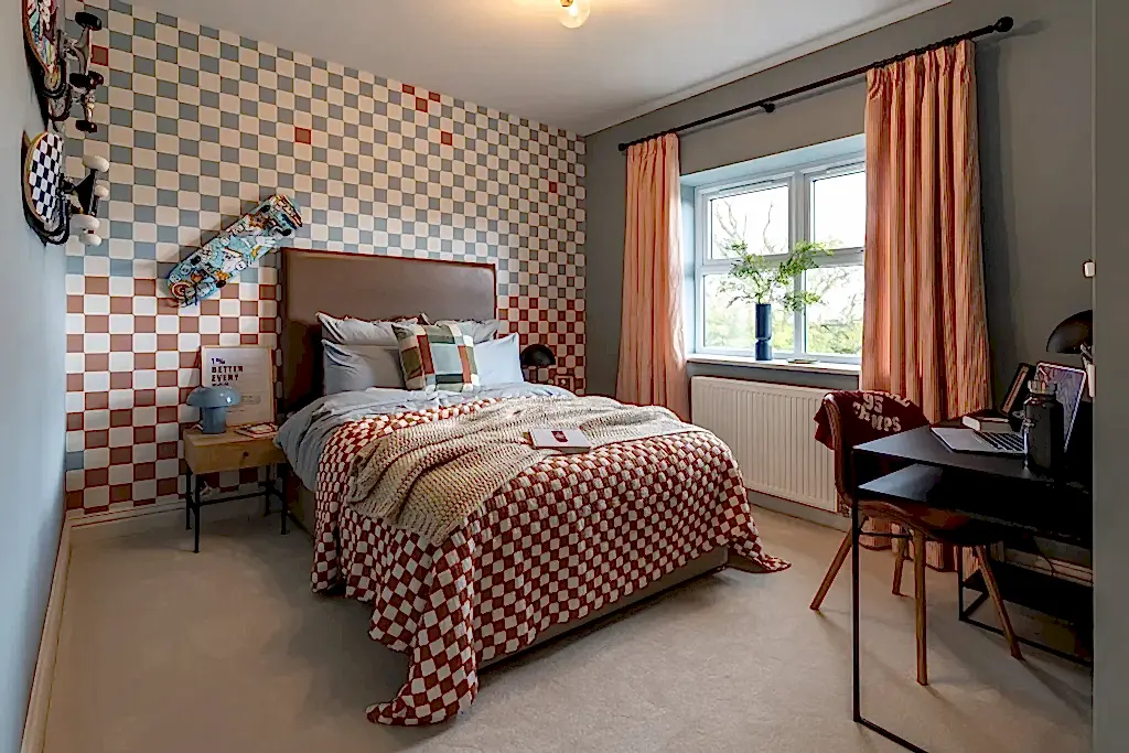Bedroom with a checkerboard feature wall, matching bedding and terracotta curtains.